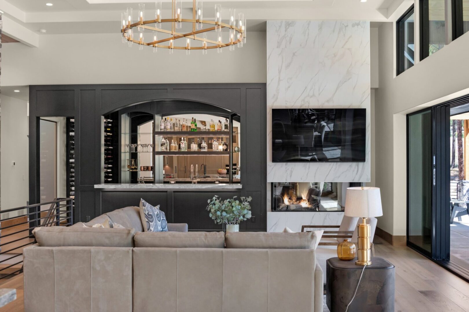 Living room with wet bar and linear fireplace