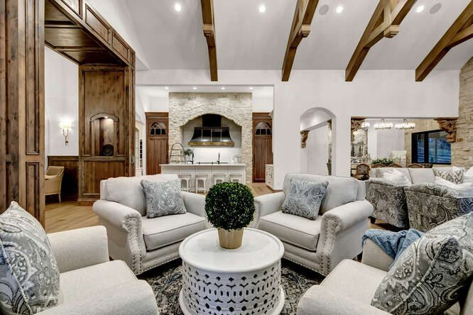 French Country living room with interior wood ceiling trusses
