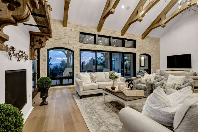 French Country living room with interior wood ceiling trusses