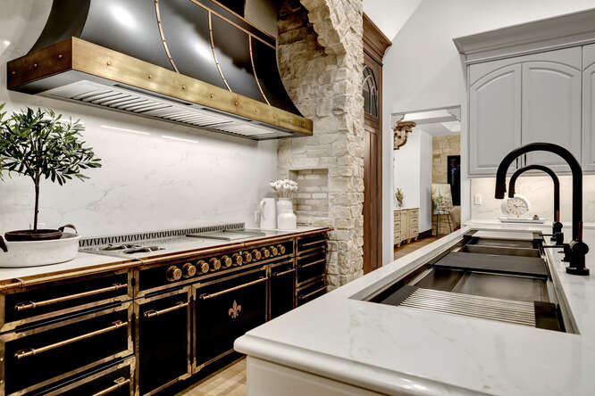 Black French range in kitchen and large sink in island