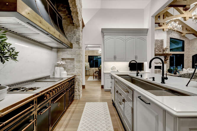 Black French range in kitchen and large sink in island