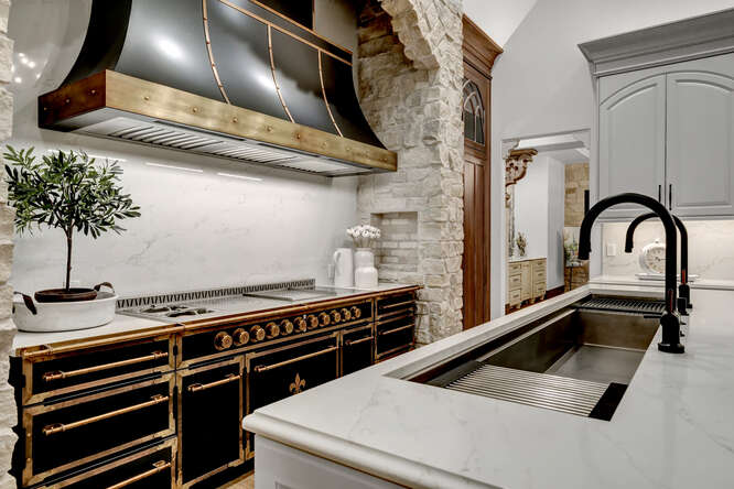 Black French range in kitchen and large sink in island