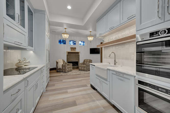 White apartment kitchen cabinets in luxury custom home