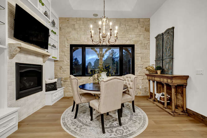Dining room with built-in fireplace and stone accent wall