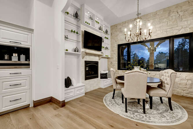 Dining room with built-in fireplace and stone accent wall