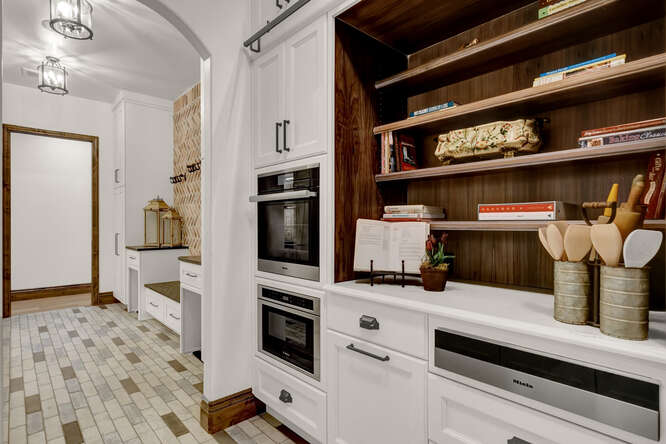 White cabinets with built-in ovens in butler's pantry