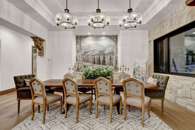 French Country Formal Dining Room with 3 crystal chandeliers and large wall tapestry