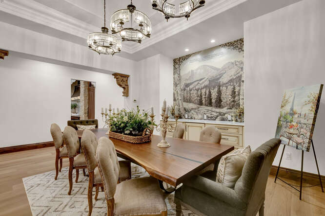 French Country Formal Dining Room with 3 crystal chandeliers and large wall tapestry