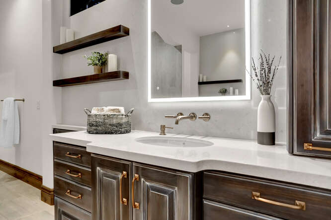 Primary Bathroom vanity with wall mount faucet and LED lit mirror