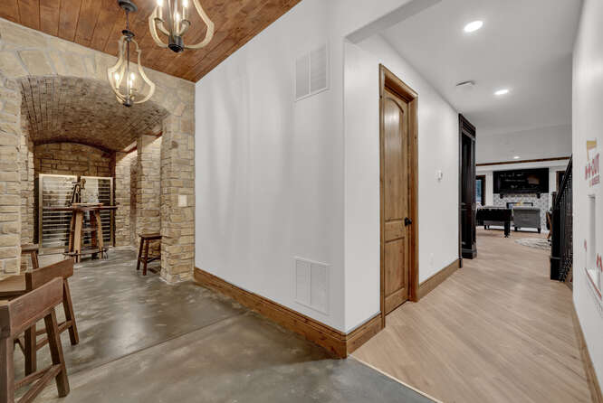 In home elevator in hallway with wine cellar nearby