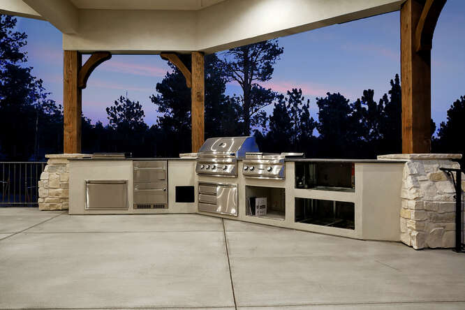 Covered outdoor kitchen with gas grill, fridge and warming drawer
