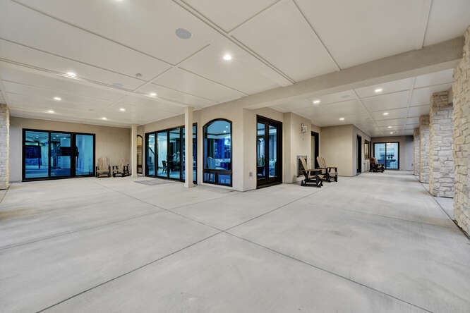 Walk out basement patio with large black windows