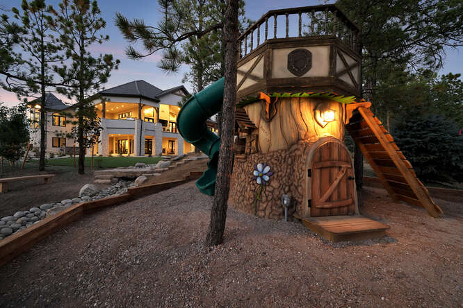 Large custom playground that looks like a cartoon house with slide