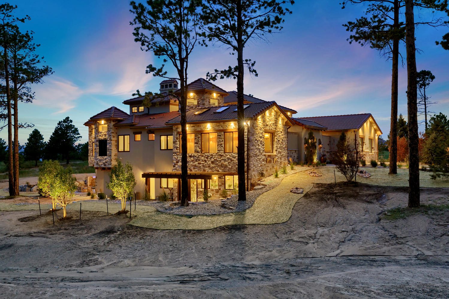 exterior elevation of Spanish style home at dusk