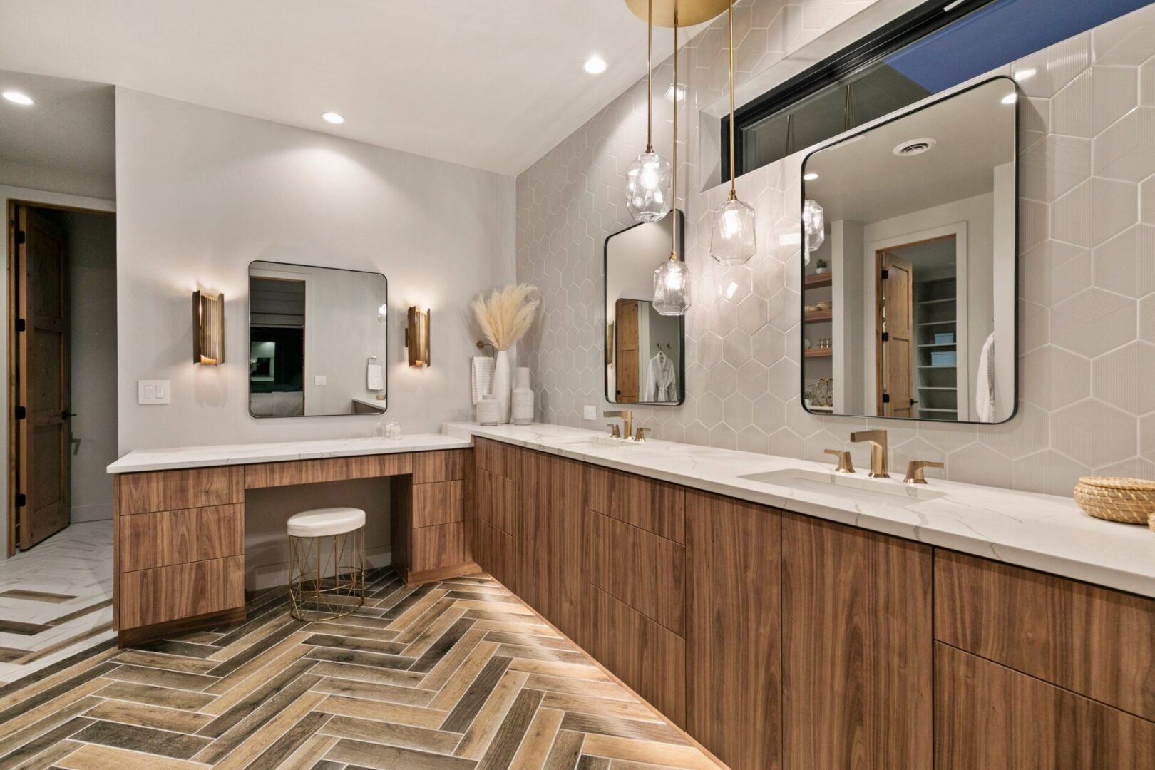 Mountain Modern Primary Bathroom with wood look tile in herring bone pattern with wood vanity and white quartzite counters