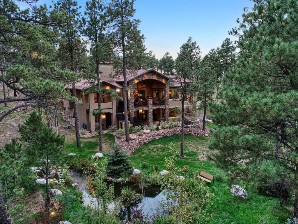 European Villa custom home with forest landscaping and fire prevention WUI precautions