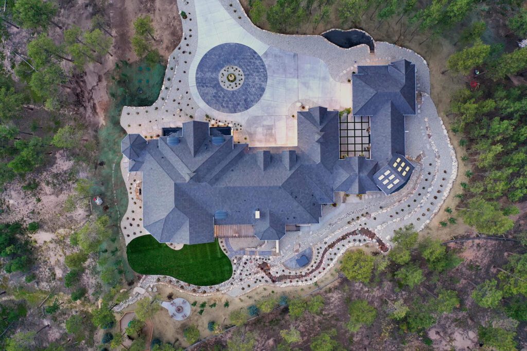 Aerial view of custom french country home with solar power options