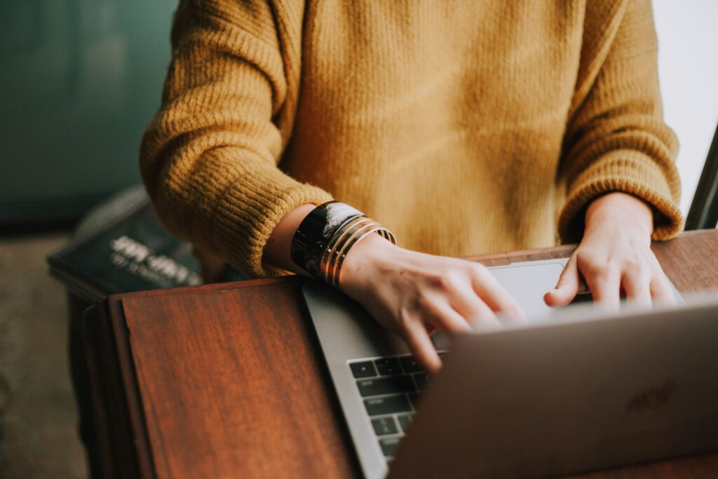 Client using communication tools on laptop for custom home building