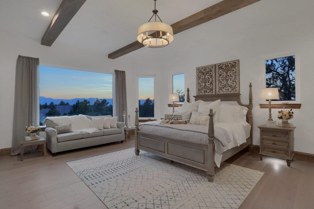 Countryside Craftsman custom home primary suite with wood beam ceiling