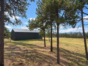 Existing 4 car garage, workshop, or barn. Sweeping front range views including Pikes Peak. Sprawling 5 acre gated, private homesite for estate lifestyle living.